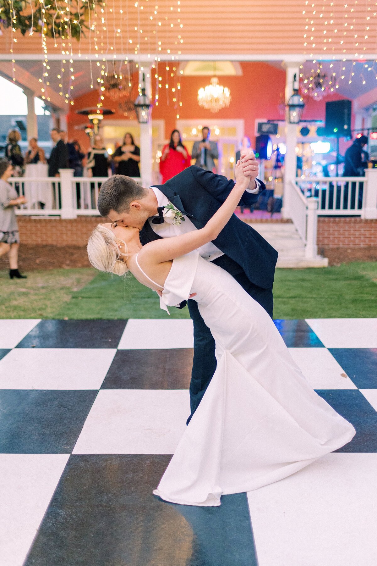 Groom dips his bride during their first dance