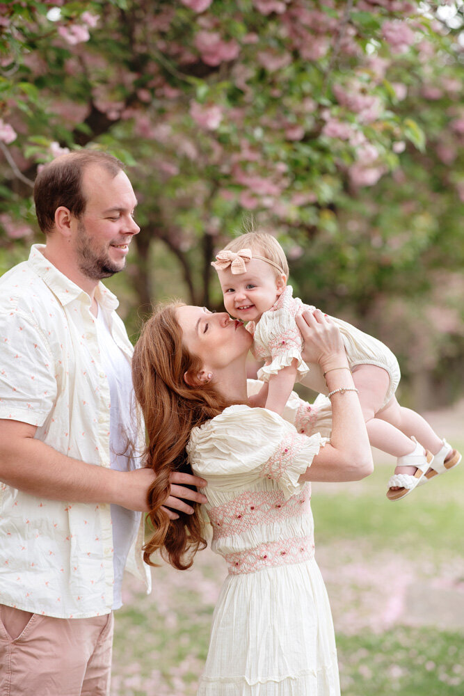 Family session of little girl and her parents outside