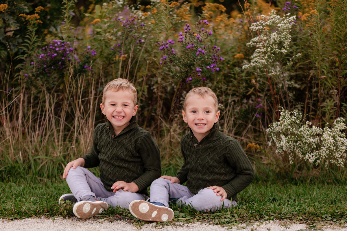 Twin brothers smile for the camera during a portrait session in Oakbrook.