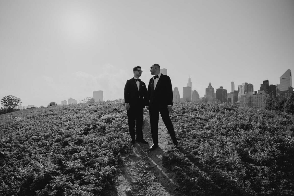 grooms holding hands during wedding photos
