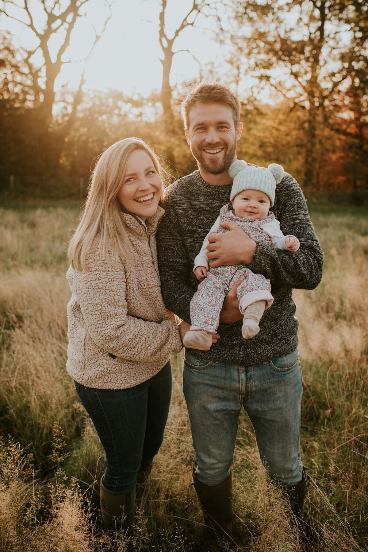 Young couple holding baby in Autumn Portraits