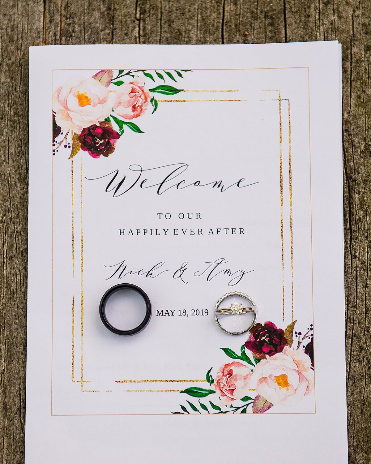 wedding program with rings in flat lay