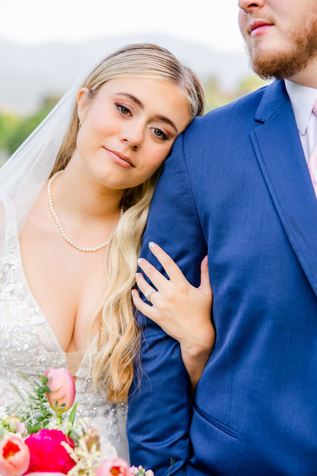 close up photo of bride holding groom's arm