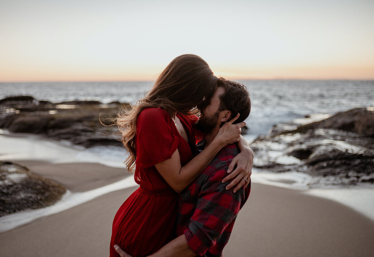 Couple kissing on the beach in San Diego California