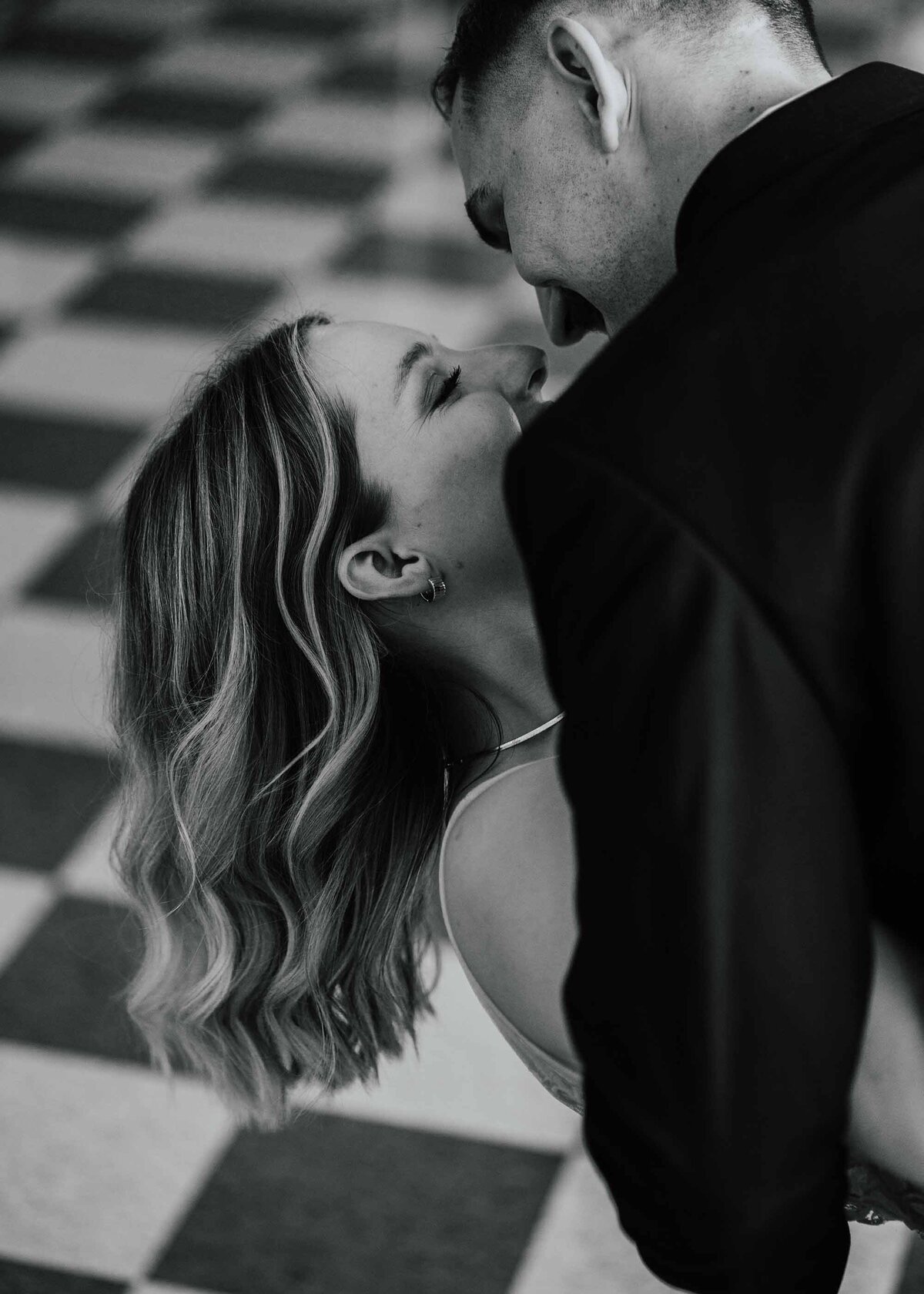 Maddie Rae Photography black and white up close images of bride and groom dip kissing . taken from behind the groom