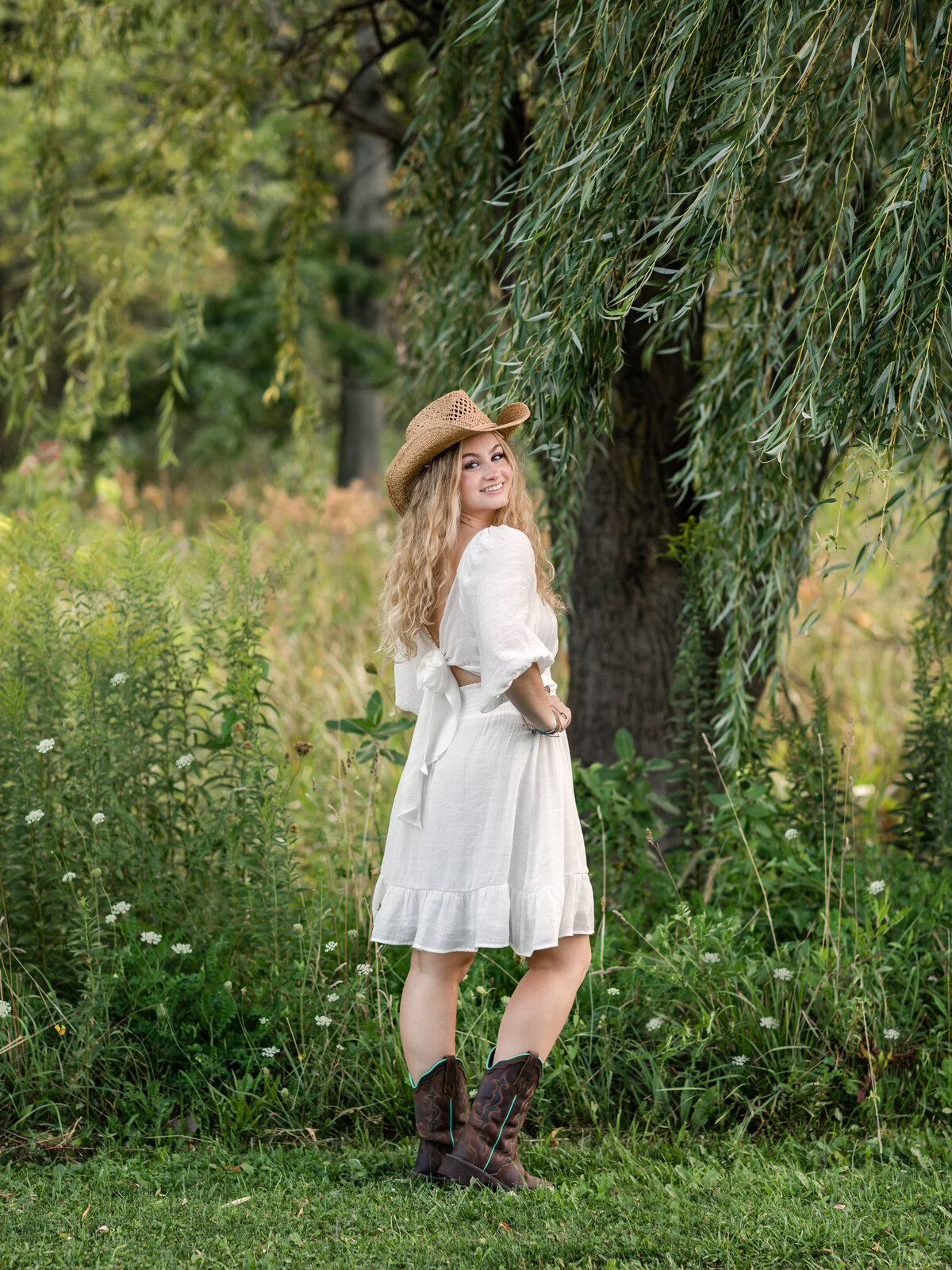 high school senior girl wearing cowboy hat for senior portraits at westcreek reservation in parma ohio