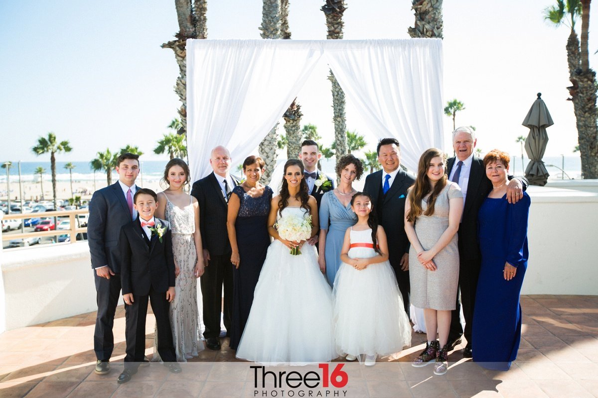 Families from both sides pose with the married couple