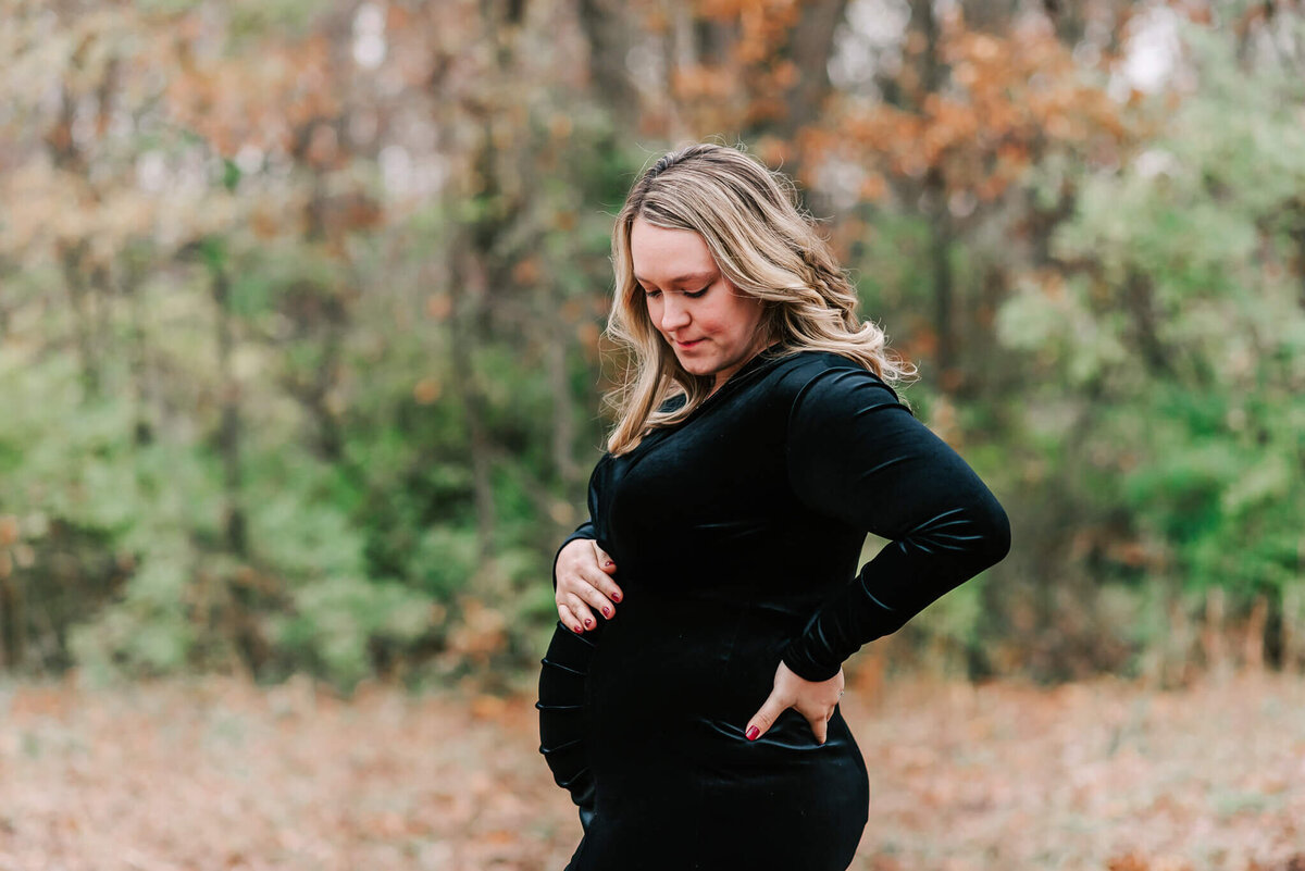 A mom gazing at her bump during her maternity session with a northern virginia maternity photographer
