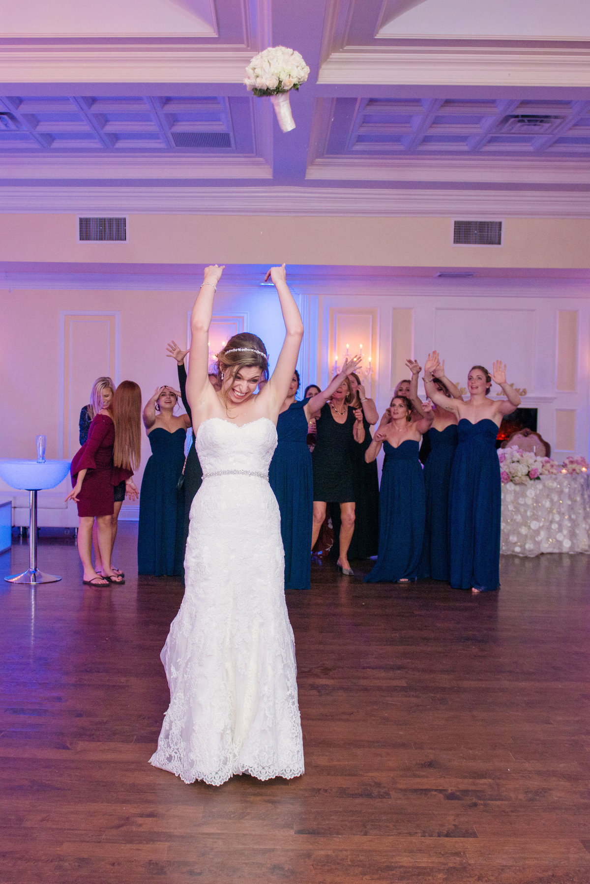 Bride throwing her bouquet at Soundview Caterers