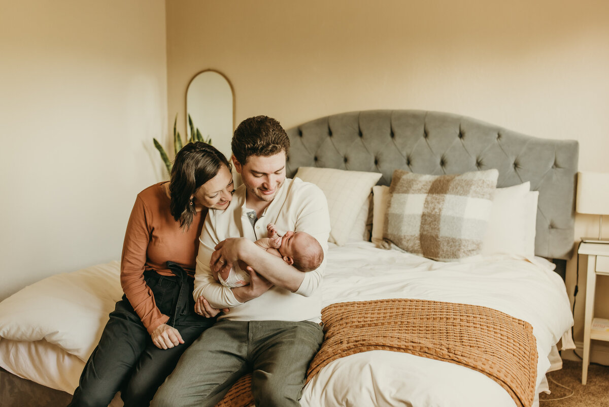 Lifestlye family photo with baby in home in master bedroom.