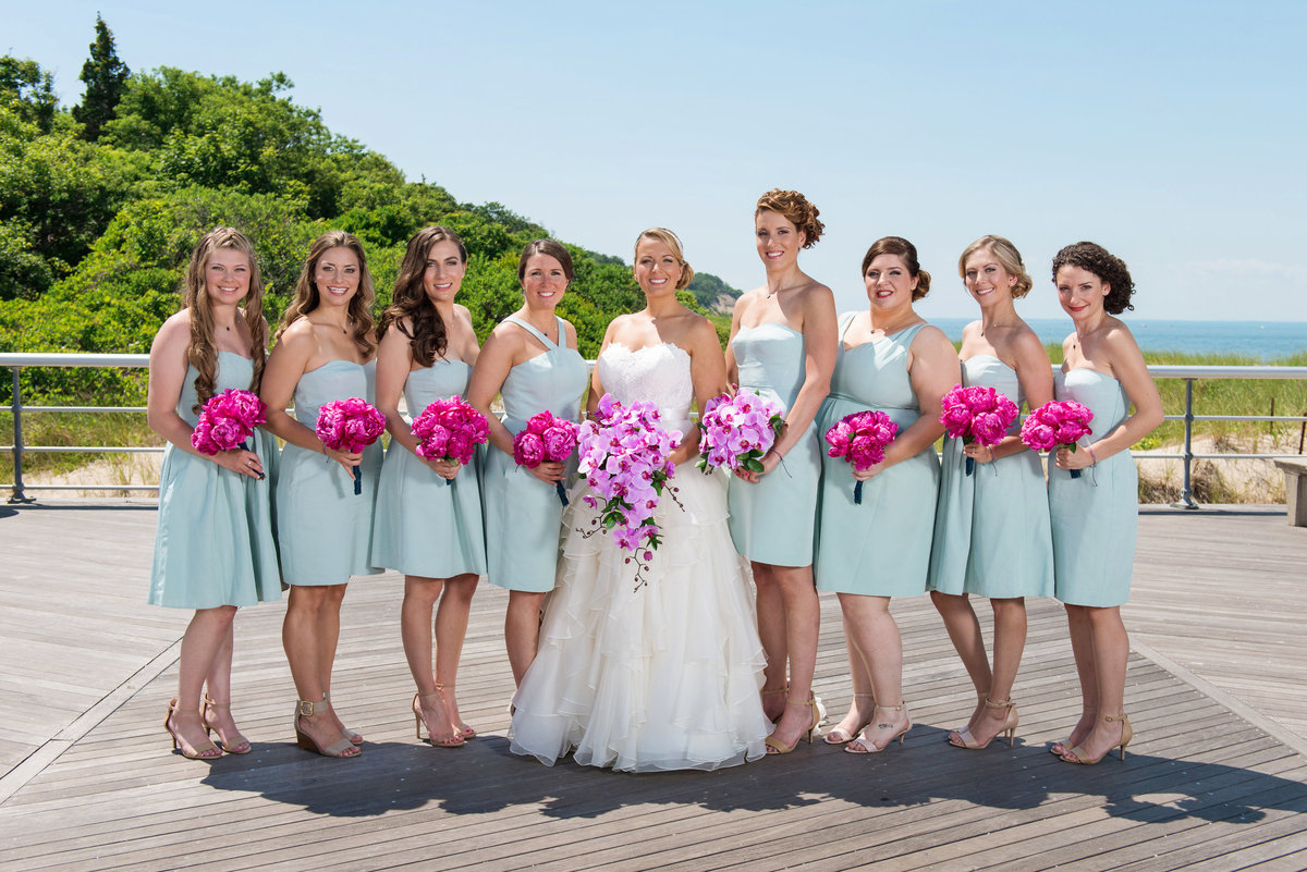photo of bride with bridesmaids on the boardwalk from wedding at Pavilion at Sunken Meadow