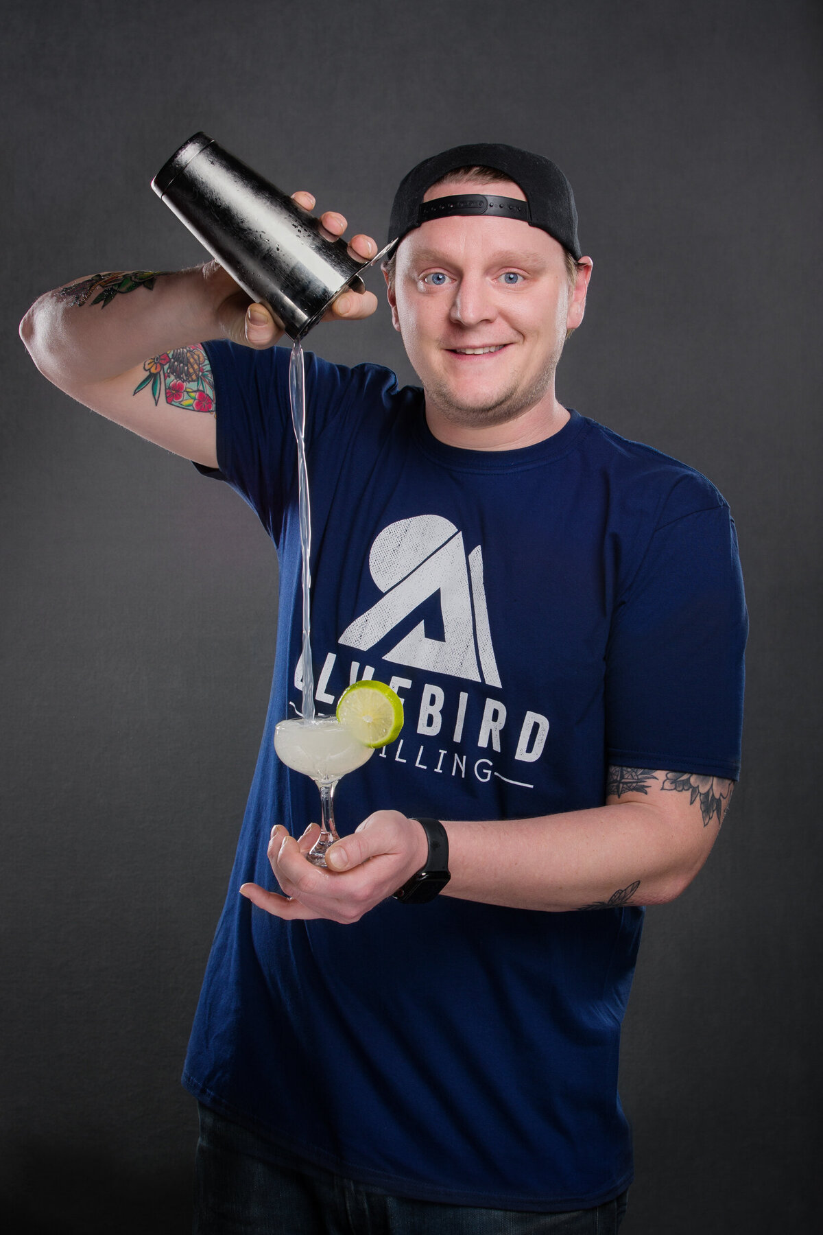 Mixologist pouring a craft cocktail for branding session and headshot photo