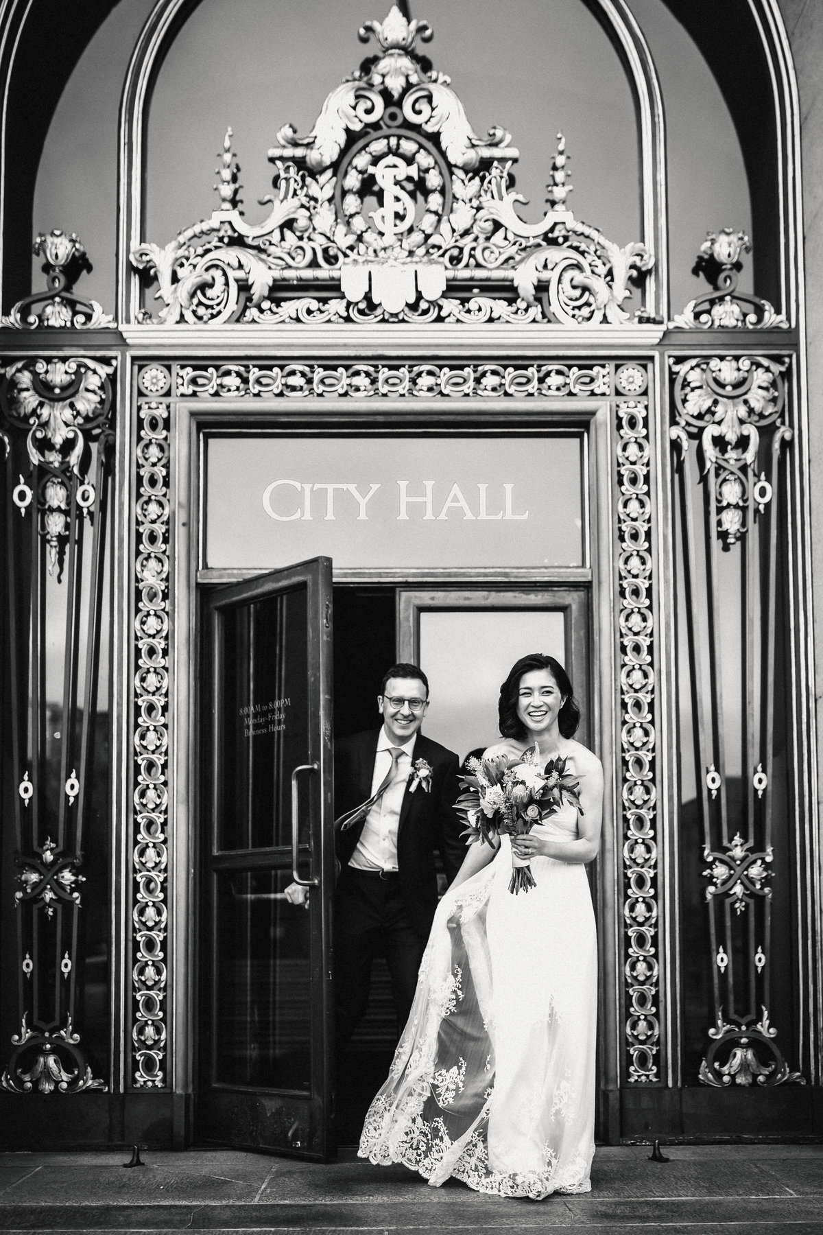 Wedding couple exits building together after their San Francisco City Hall elopement