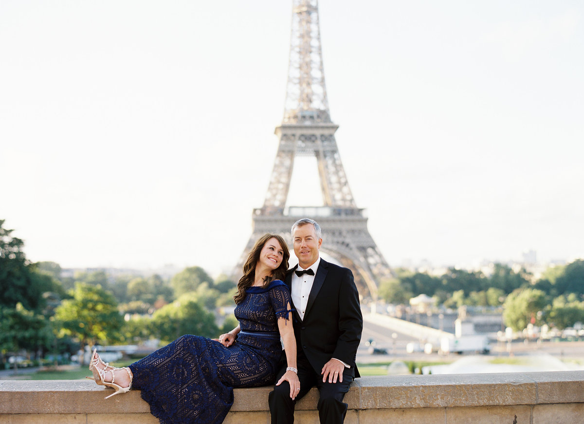 Married couple in evening wear celebrate their anniversary with photos in front of Eiffel Tower