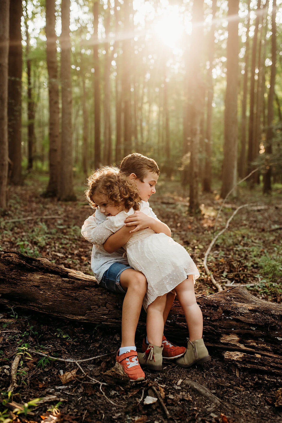 boy and girl hugging on a  log near washington DC