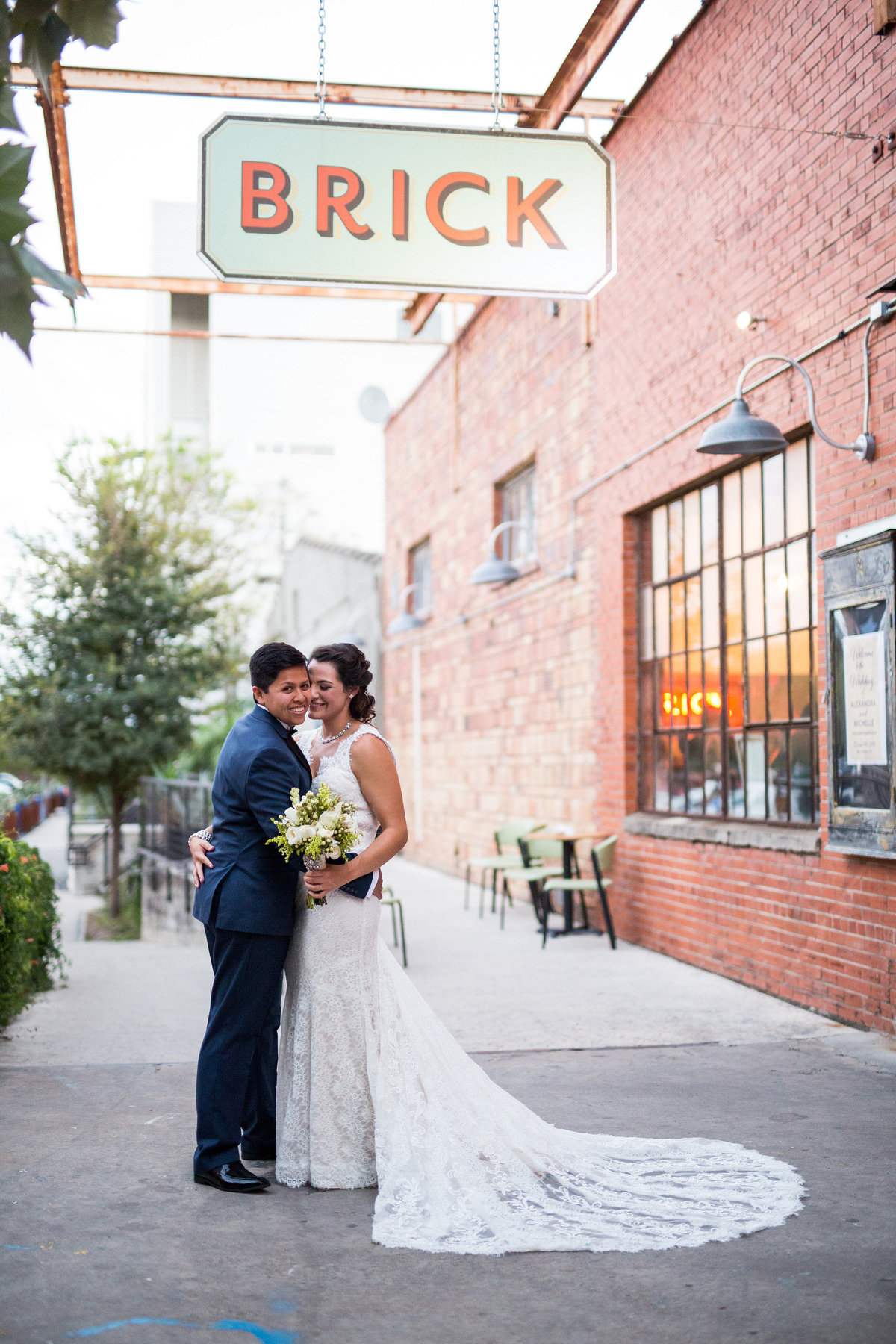 Married couple posing for San Antonio Wedding Photographer at Brick at Blue Star wedding venue