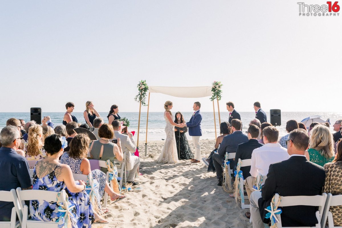Bride and Groom saying their vows during a Crystal Cove State Beach wedding ceremony