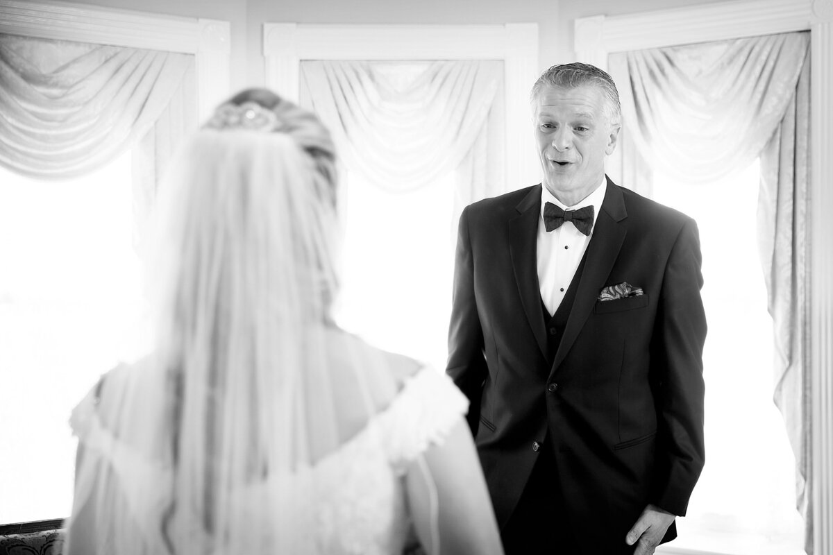 A father sees the bride for the first time on her wedding day.