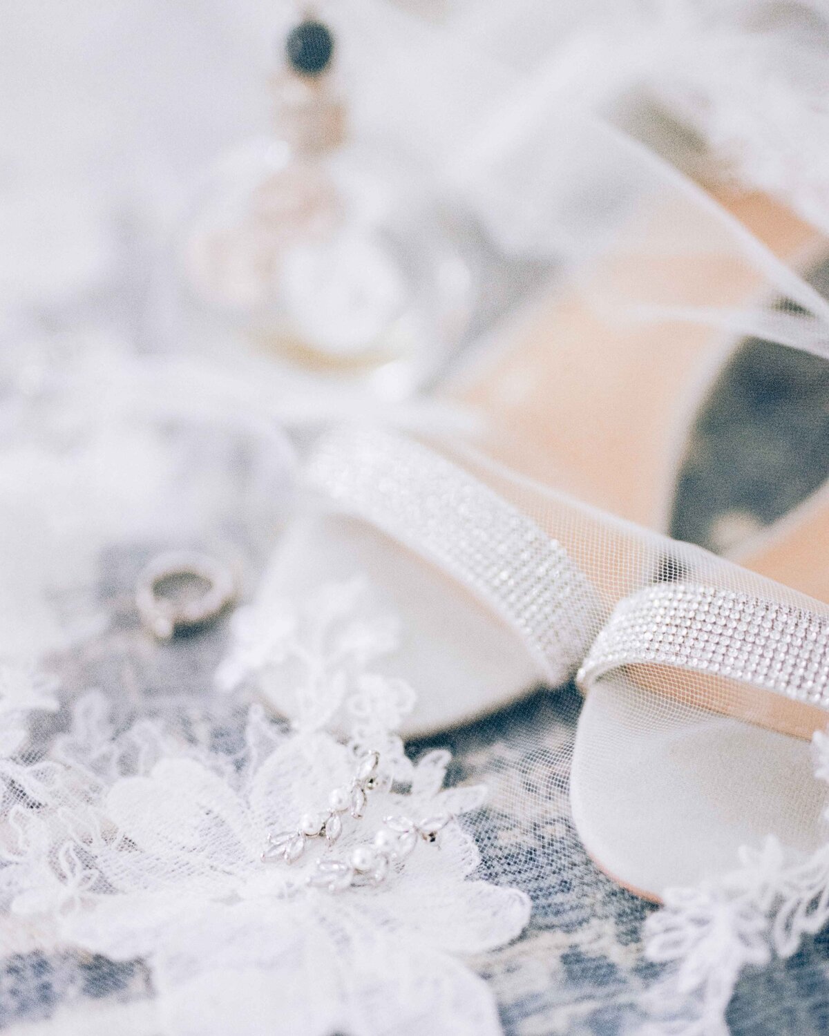 Bride's Veil, Shoes, Rings, and Perfume During  Wedding Day Preparation Detail