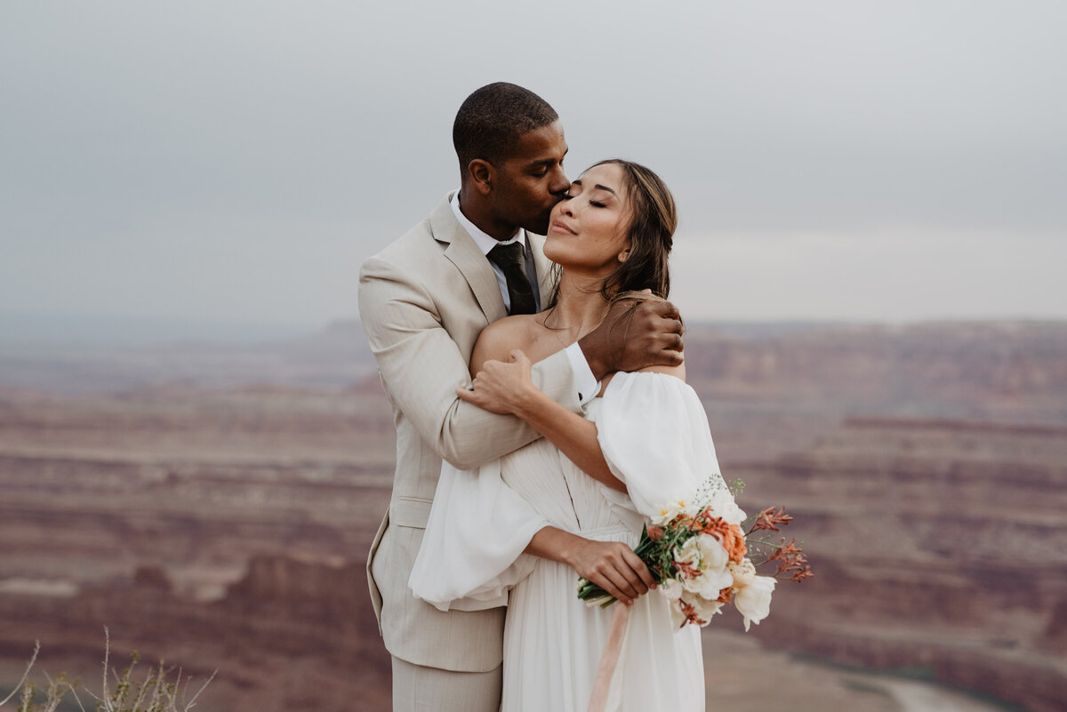 Utah Elopement Photographer captures groom kissing bride's cheek