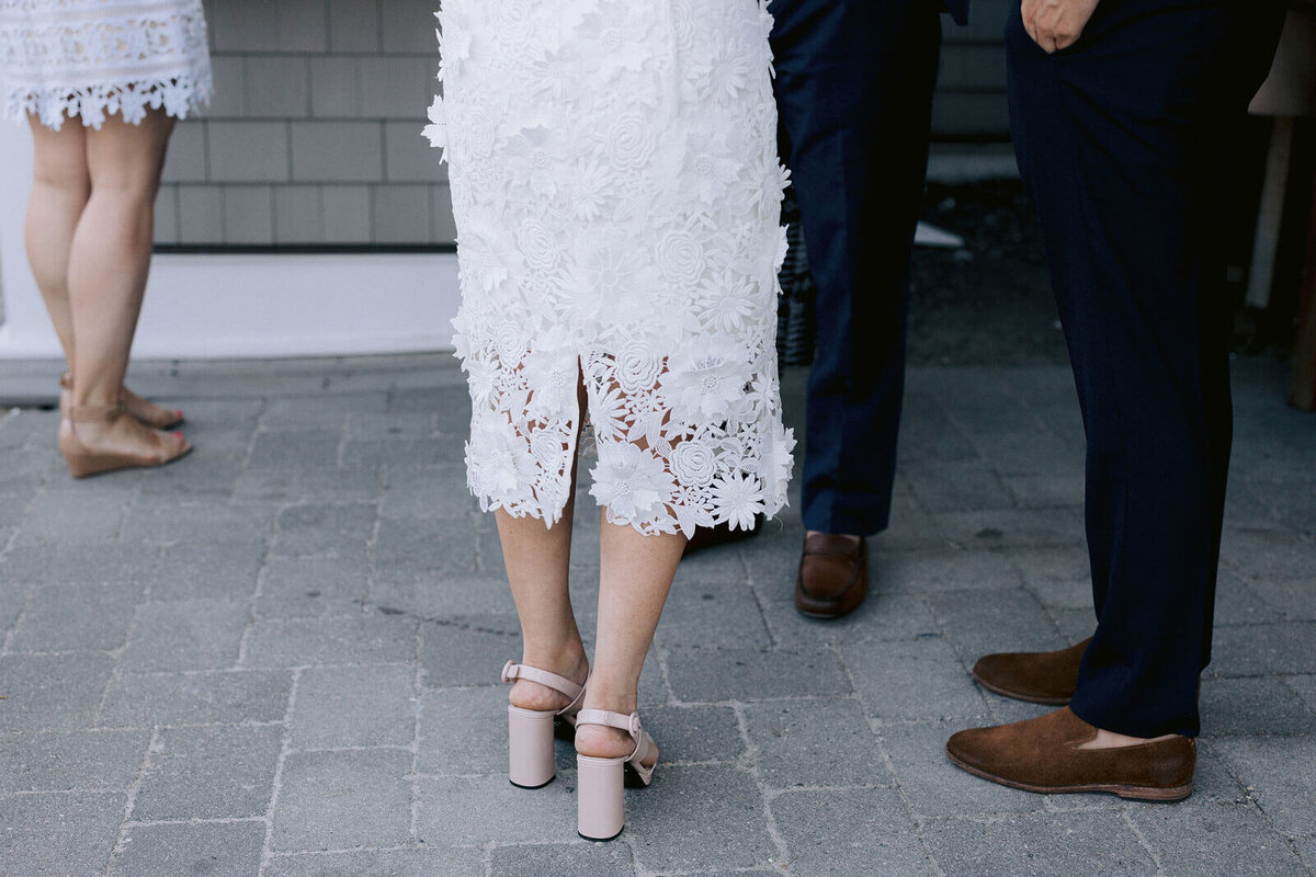 Lower half-body view of the bride and the groom, showing their shoes, at Cape Cod, Osterville, MA.