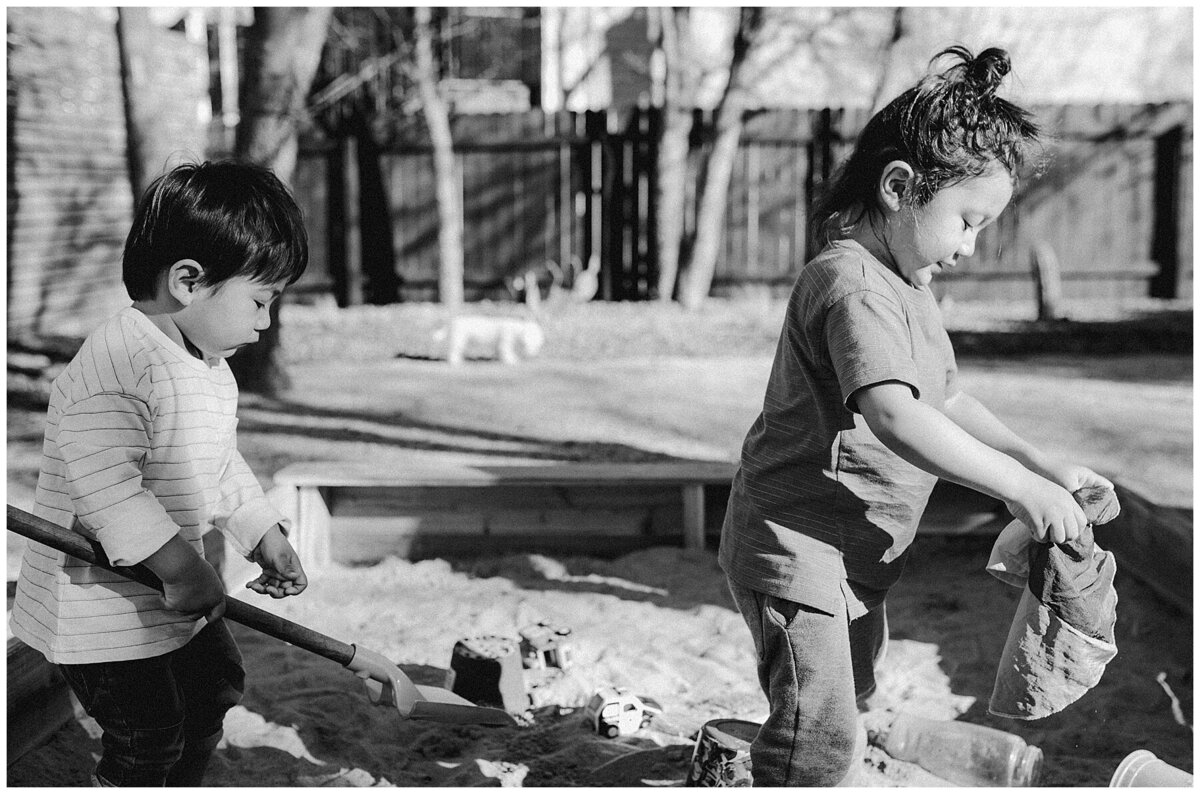 Children playing in a sandpit at  garden family session in Austin by Amber Vickery Photography
