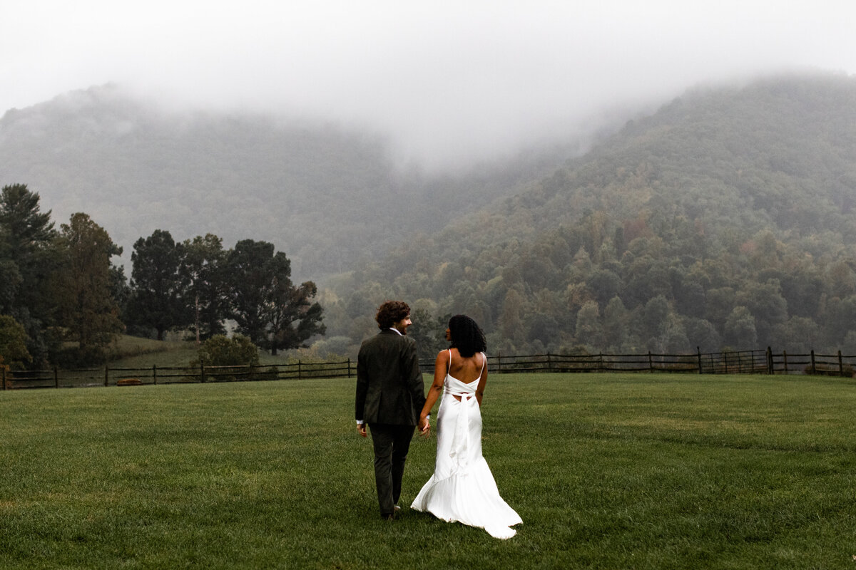 back of bride and groom going into the mountains.Elopements and Weddings in Nature's Embrace