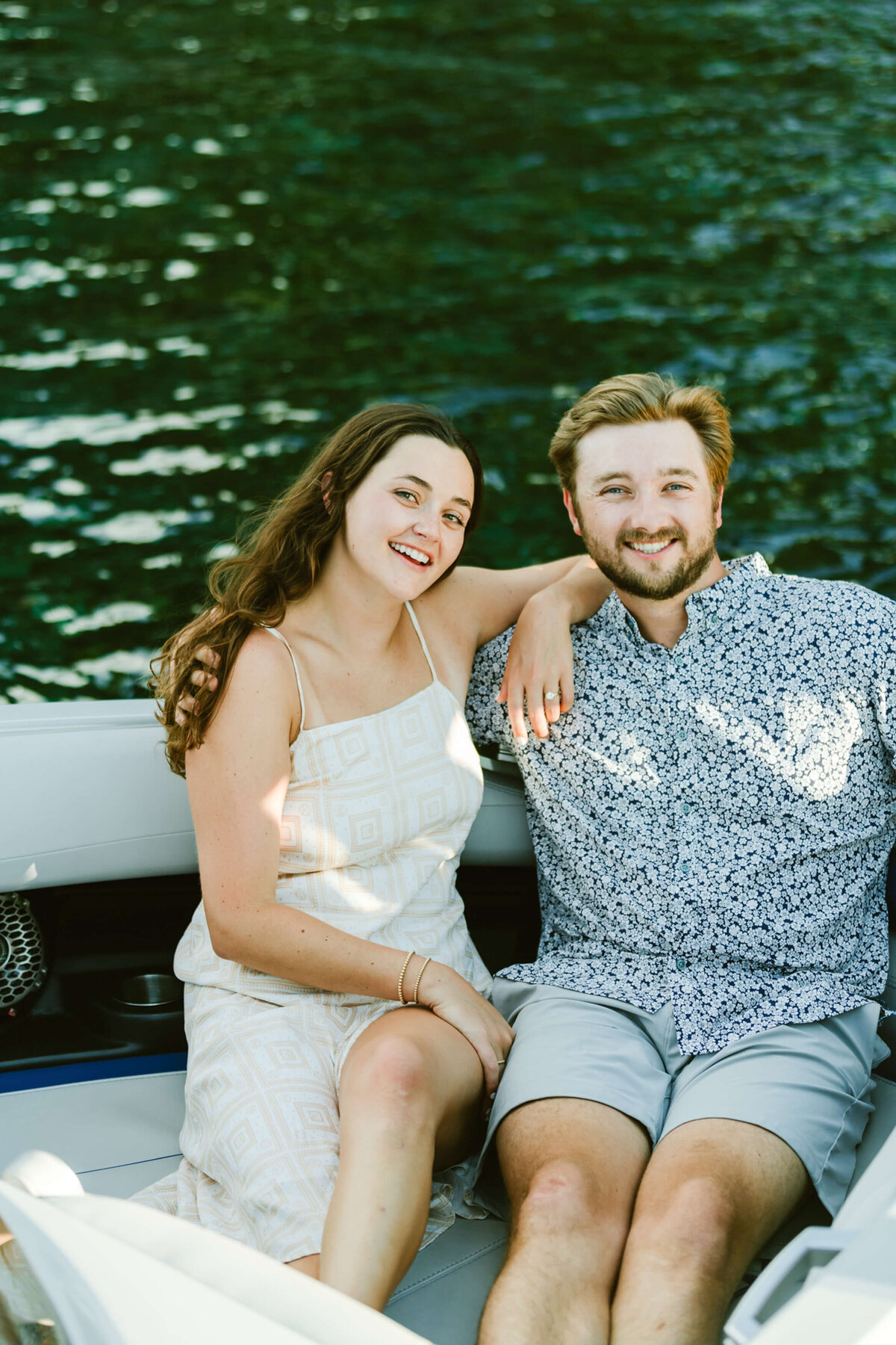 engagement with boat couple sitting in boat looking at camera