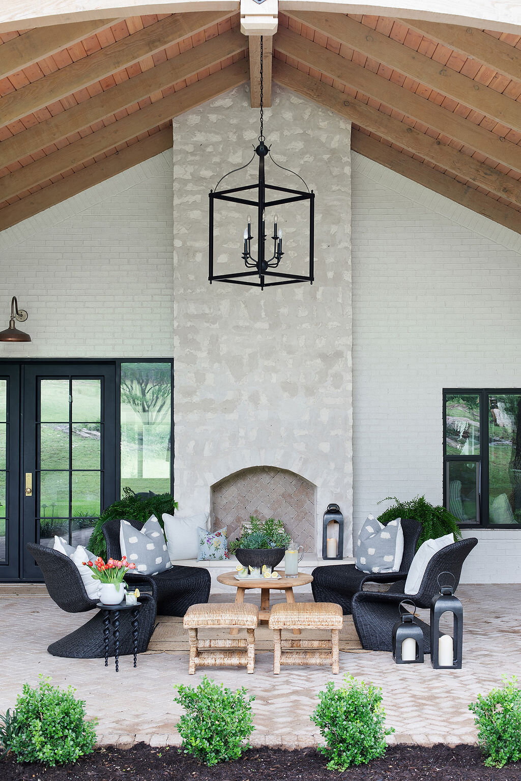 large outdoor seating area with fireplace and chandelier