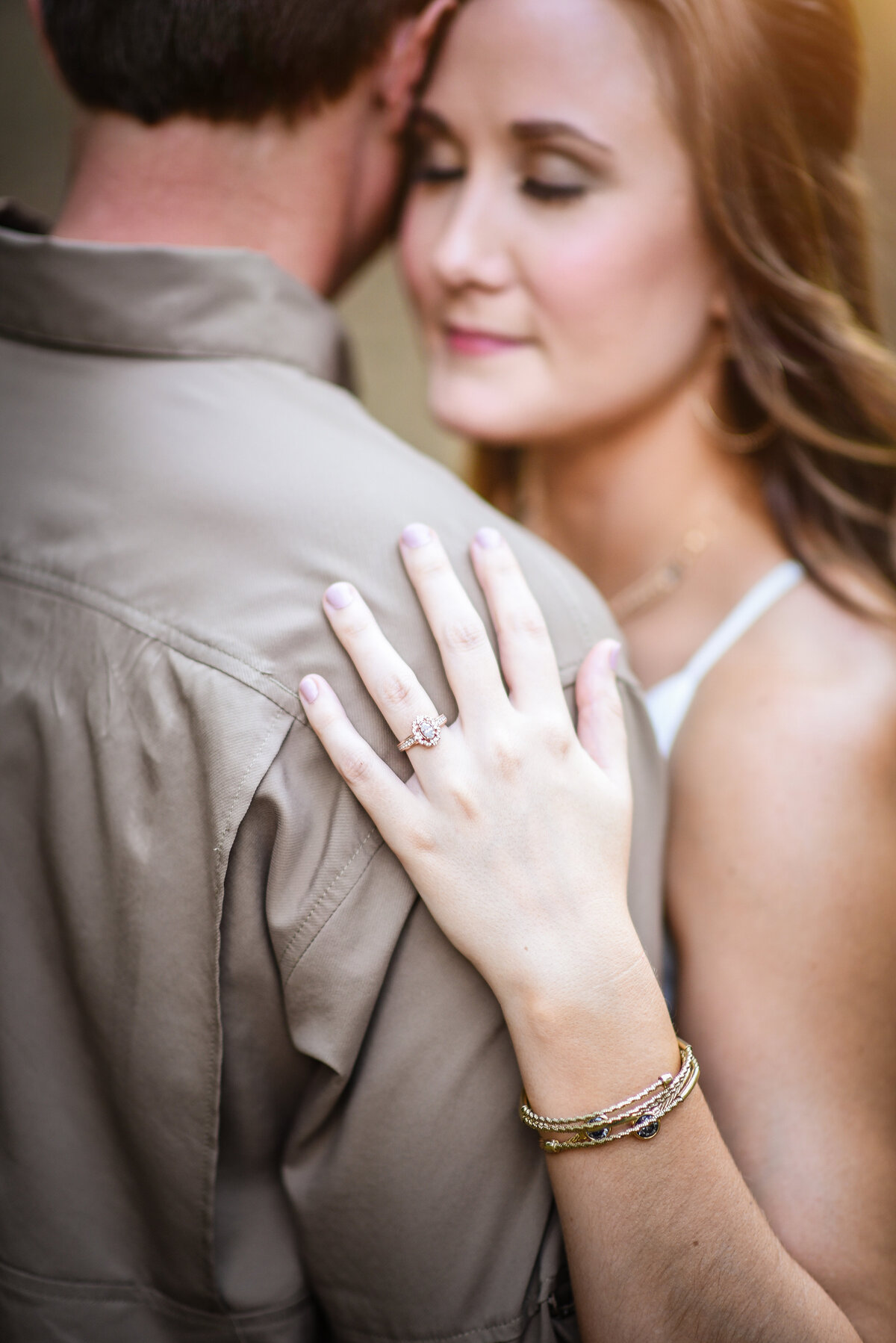 Beautiful Mississippi Engagement Photography: Bride shows off ring holding onto fiance's arm in MS Delta Pecan Orchard