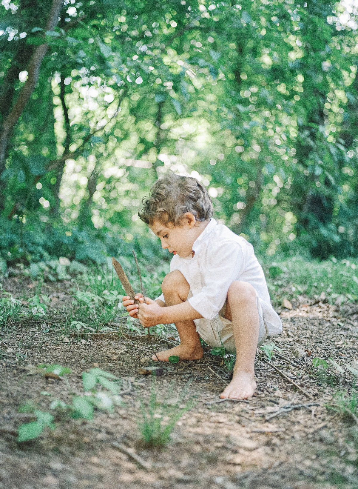little boy playing in asheville dirt
