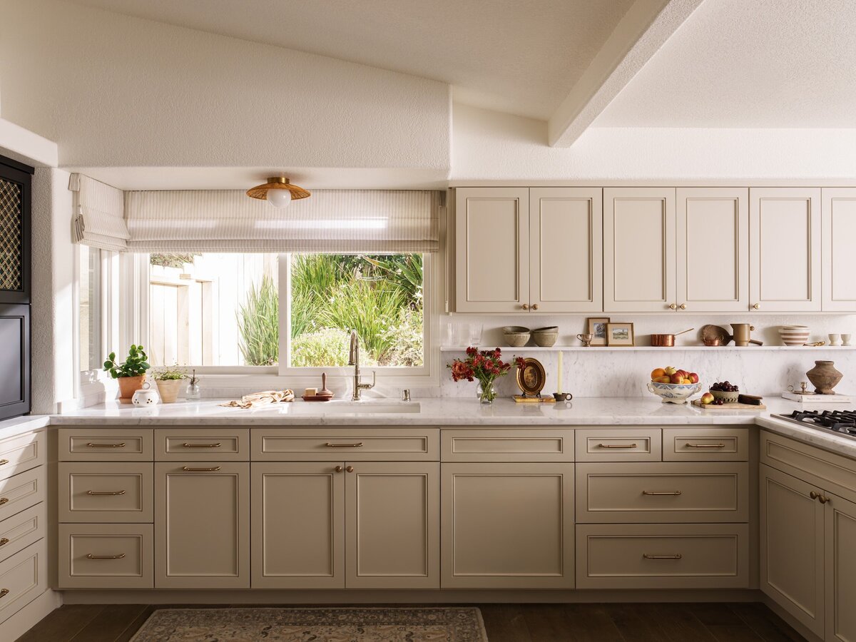 Full kitchen remodel with beaded shaker cabinets with brass hardware. white oak wood floors