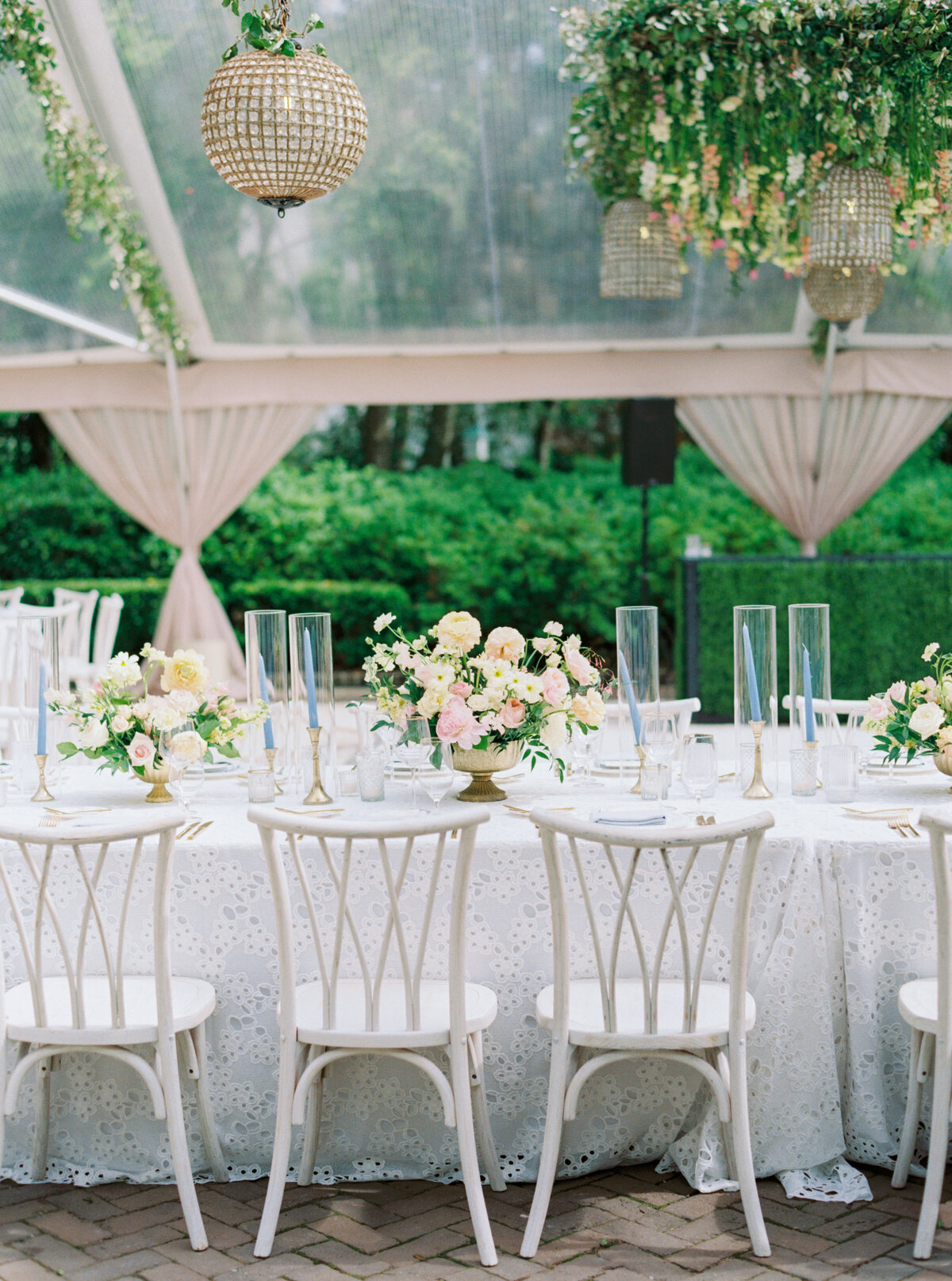 White chairs and table linens. Pale pink and yellow flowers with white and green. Charleston spring wedding.