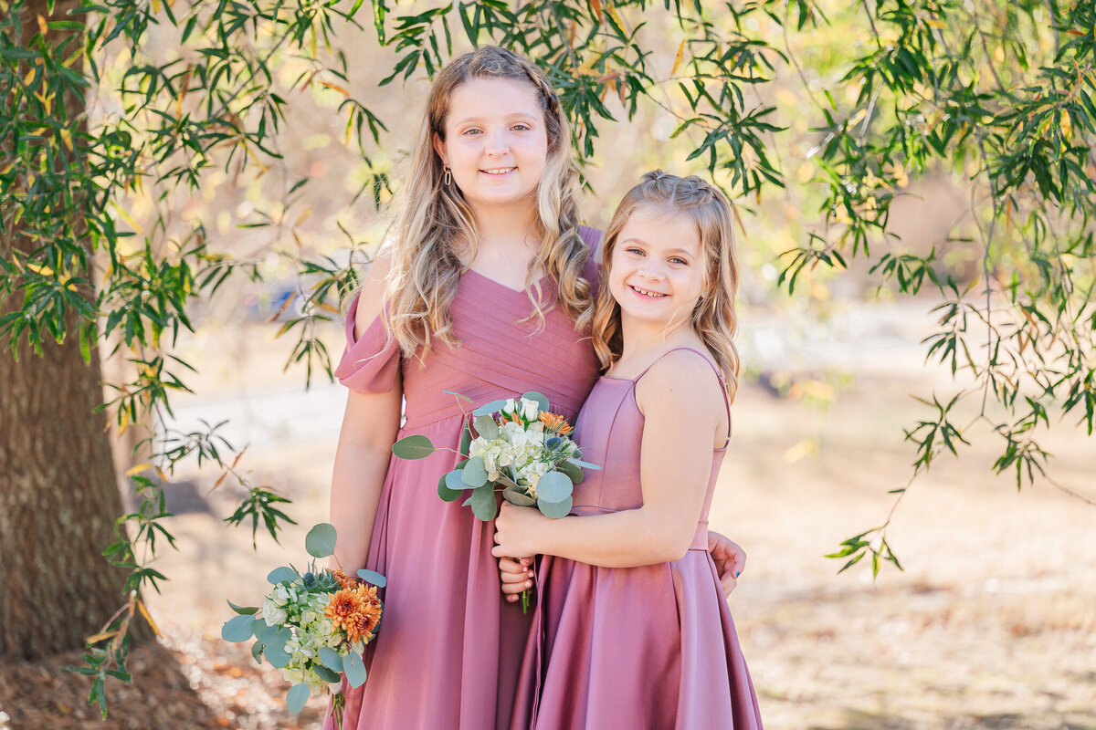 Two junior bridesmaids in Raleigh before the wedding ceremony by JoLynn Photography, a North Carolina wedding photographer