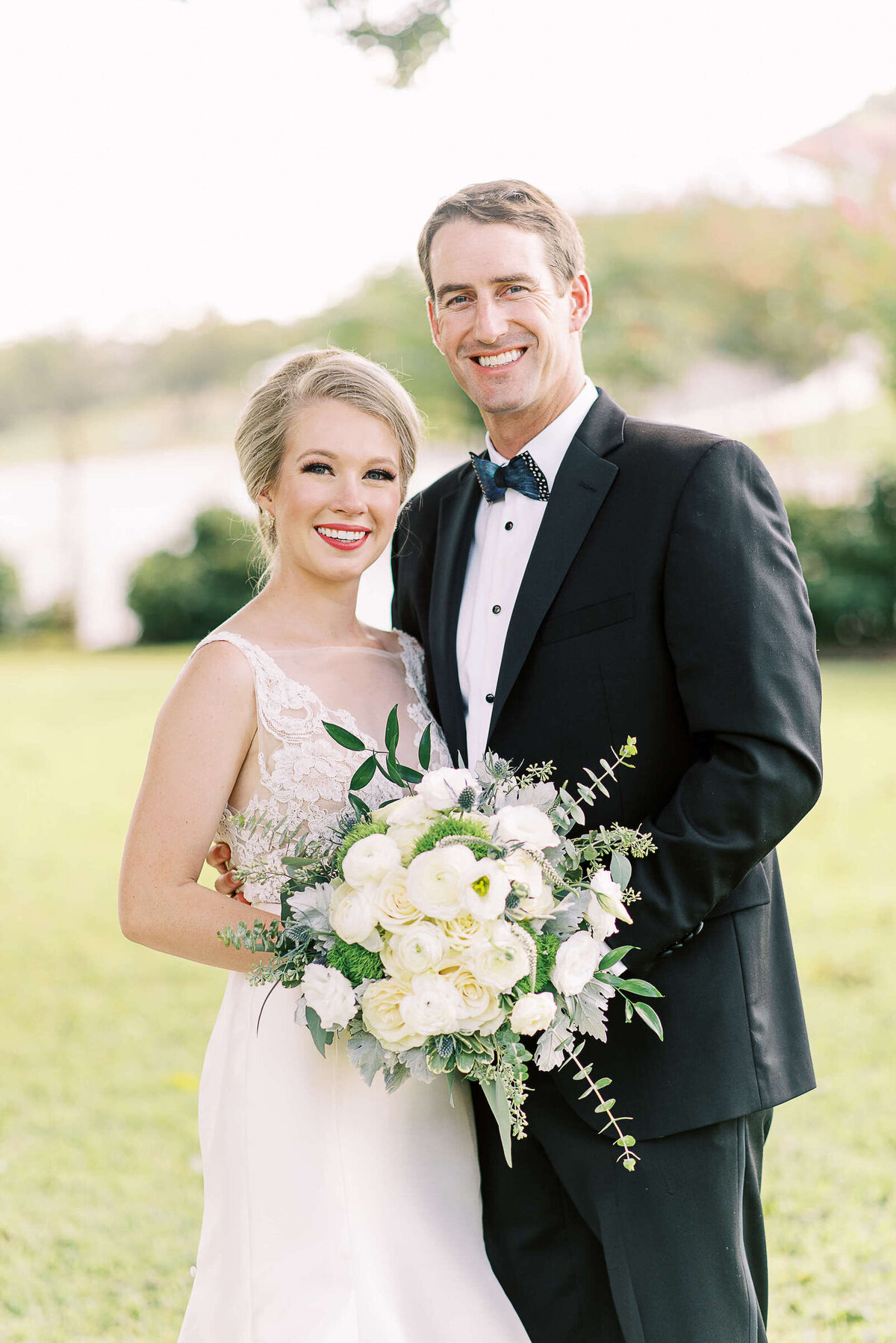 Classic style bride and groom smile in the Texas hill country