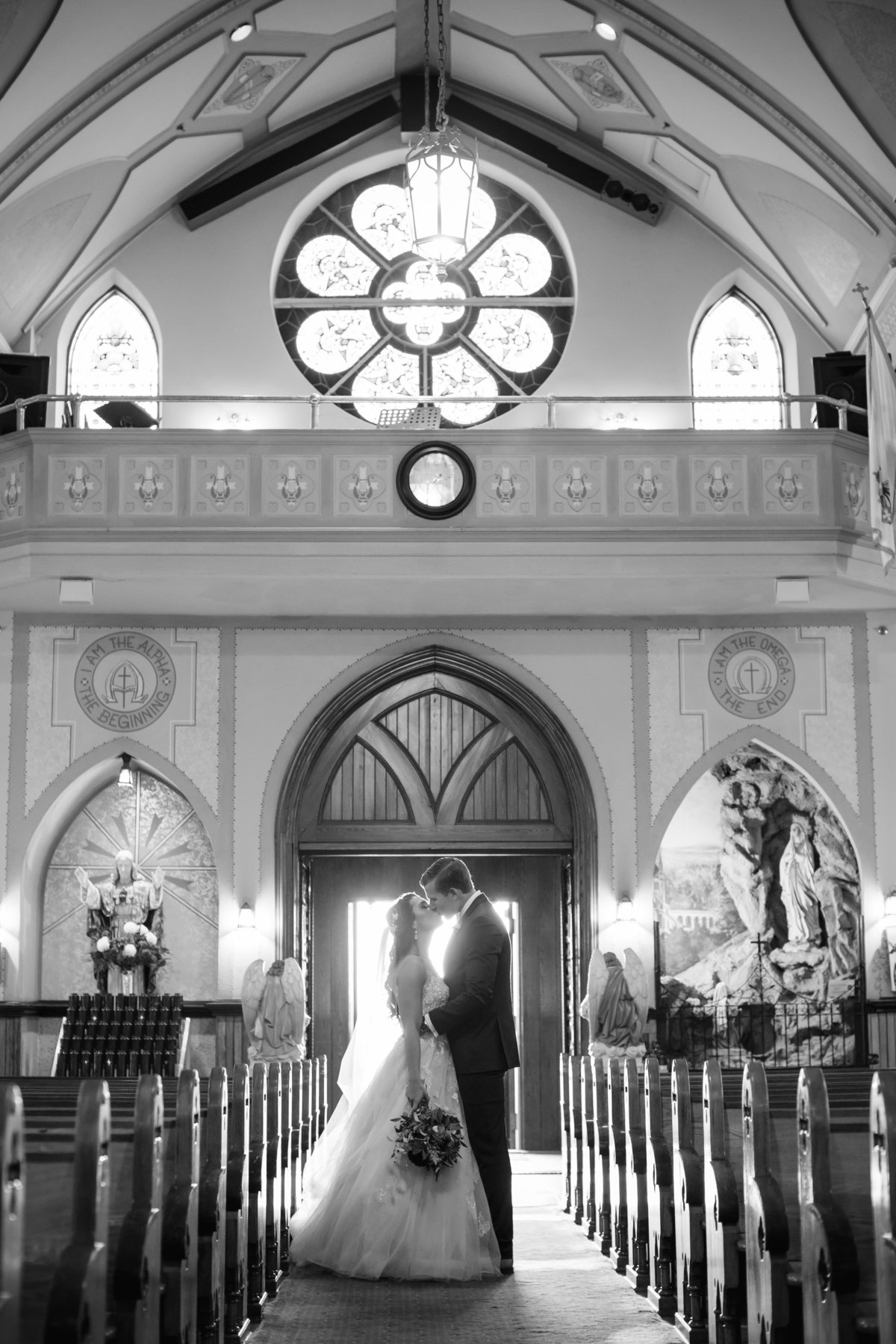 bride and groom kissing after church ceremony at saint catharines church