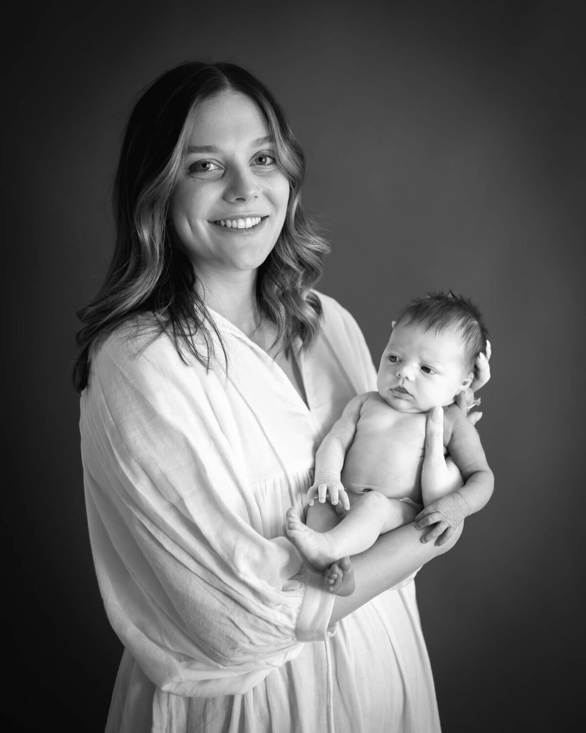 black and white studio portrait of mom with baby