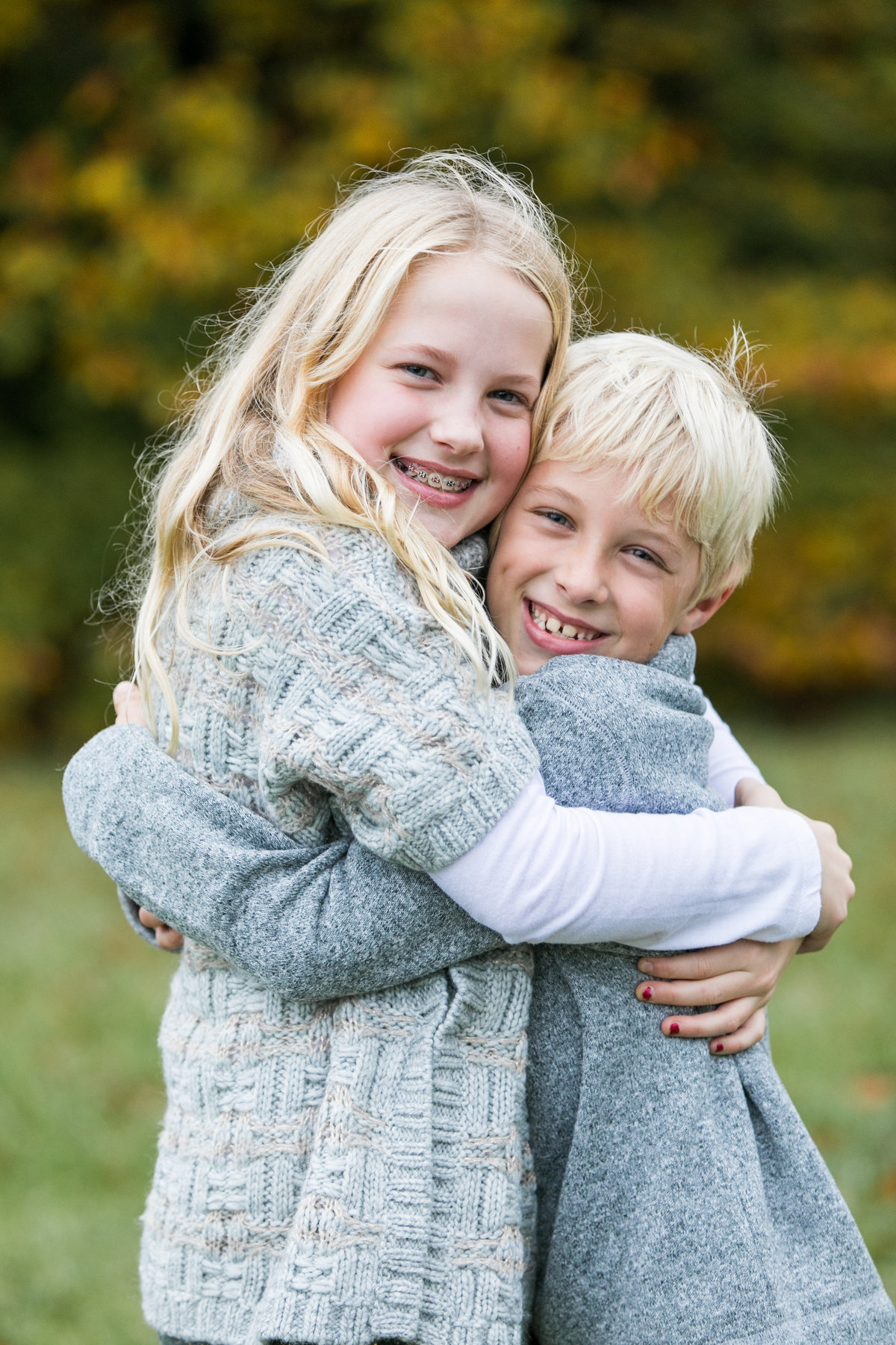 Brother-sister-smiling-for-portraits