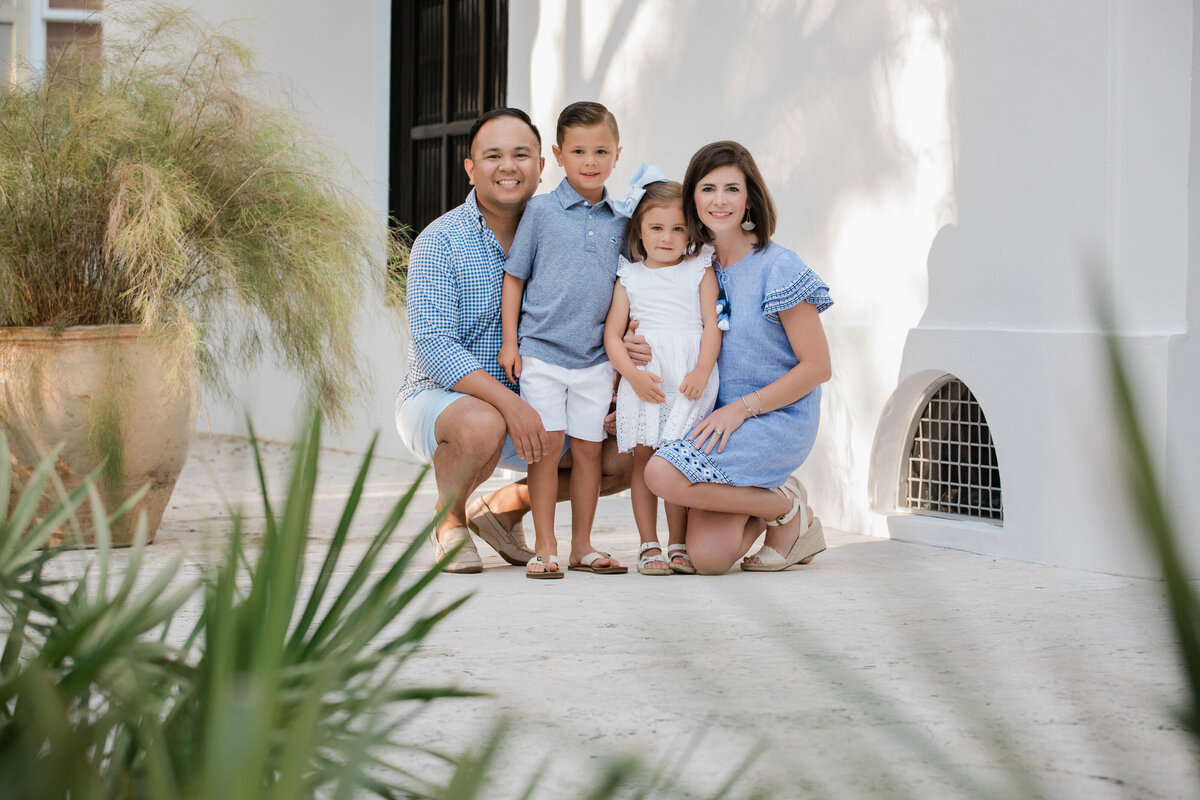 Parents crouched down and smiling with their kids