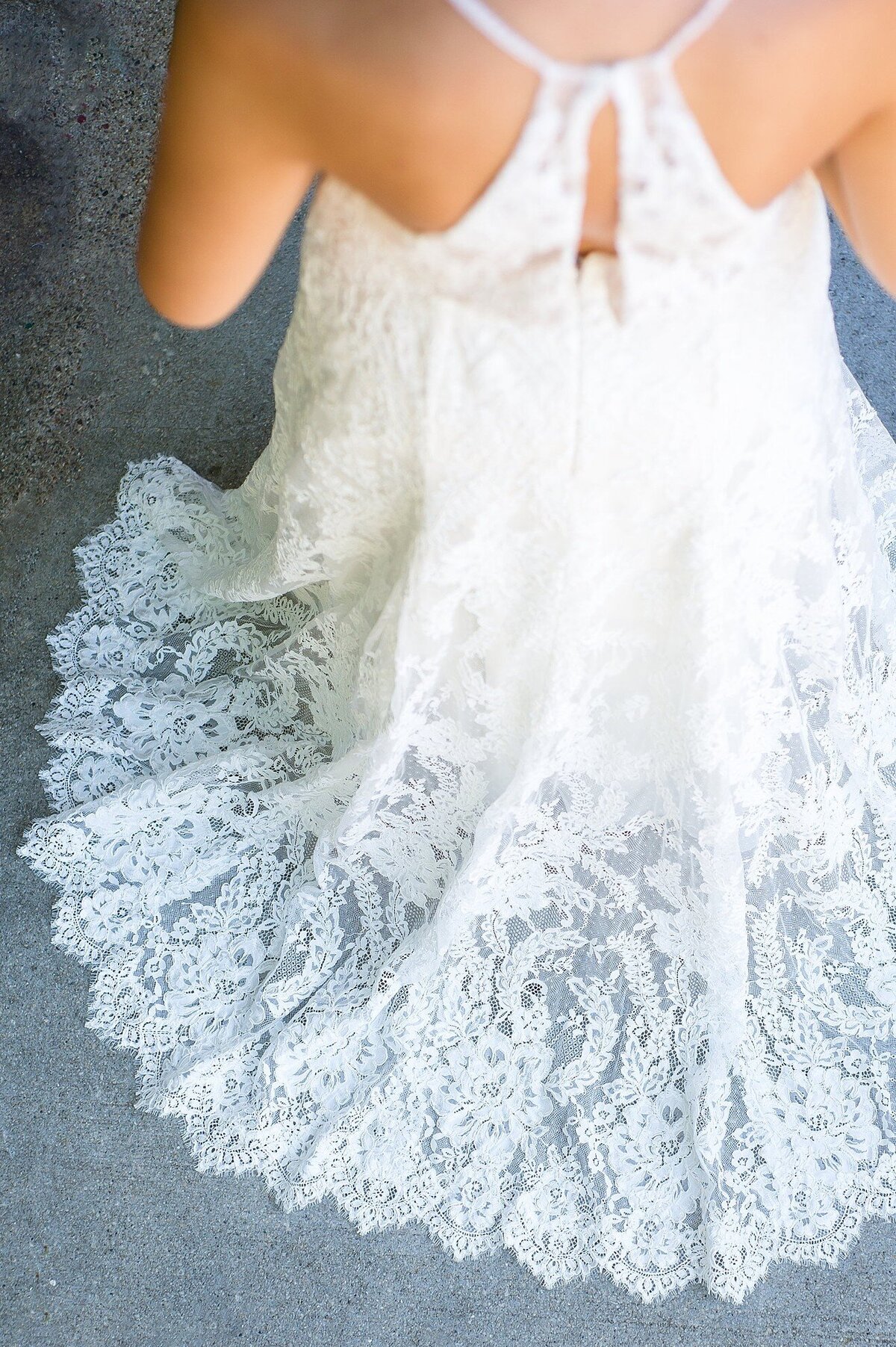 The chapel length train on the Sabine all-lace wedding dress is sheer and finished with a scalloped edge.