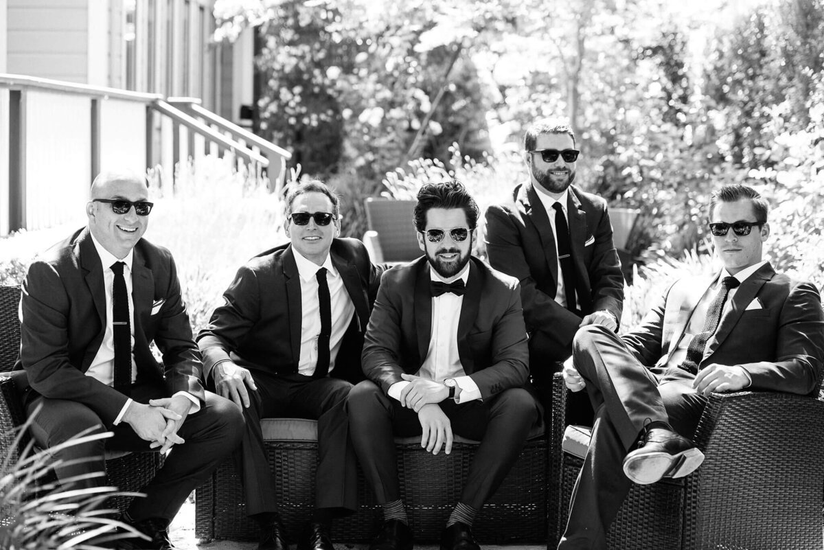 black and white groom and men sitting in Napa