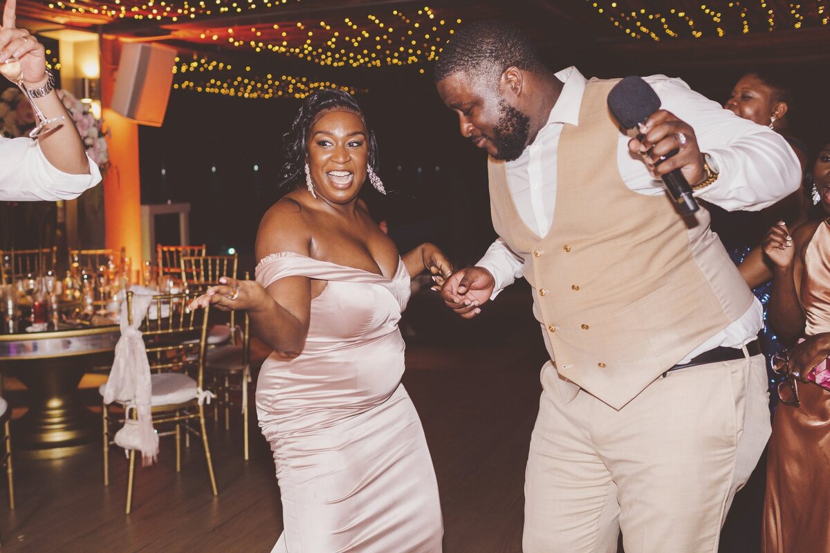 Bridesmaid dancing with groomsman