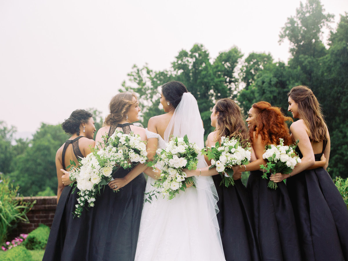 bride and bridesmaids with white bouquets