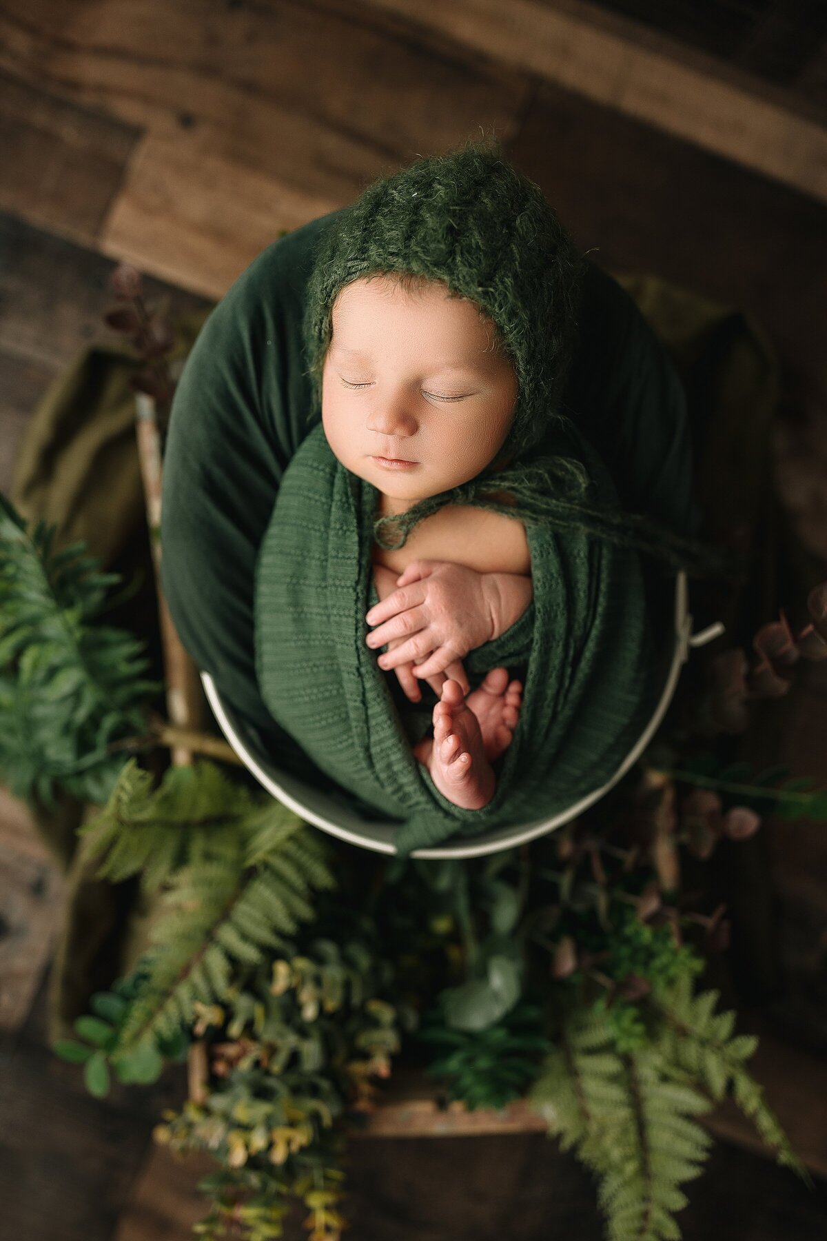 Posed newborn photography in green