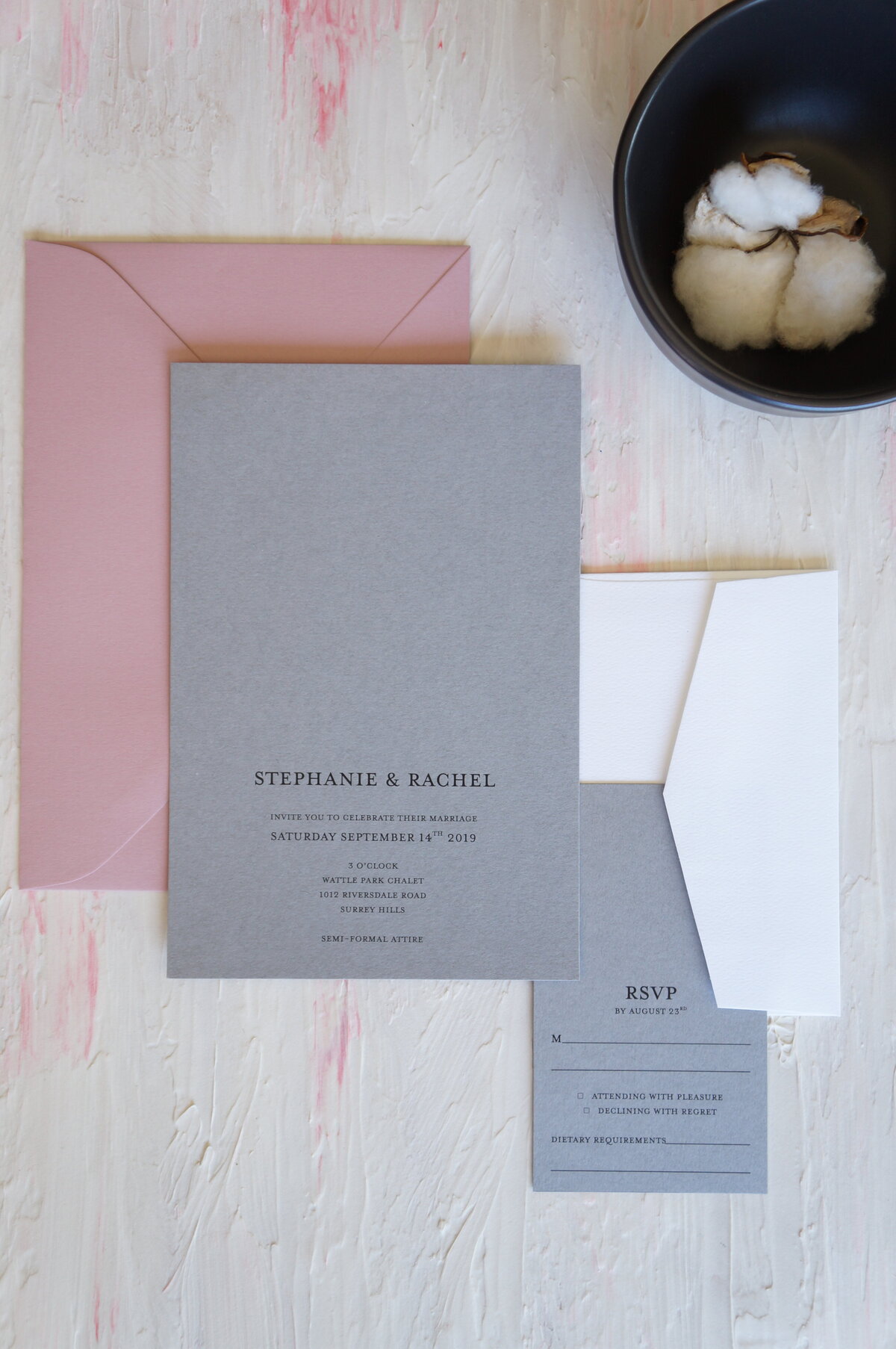 Grey and white minimalist wedding invitation with pink envelope