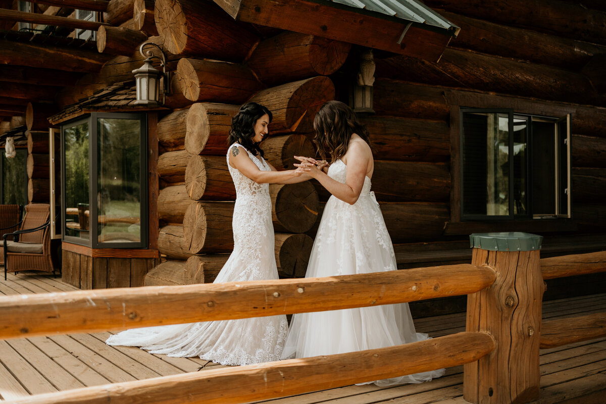 same sex couple in their wedding dresses having  a first look