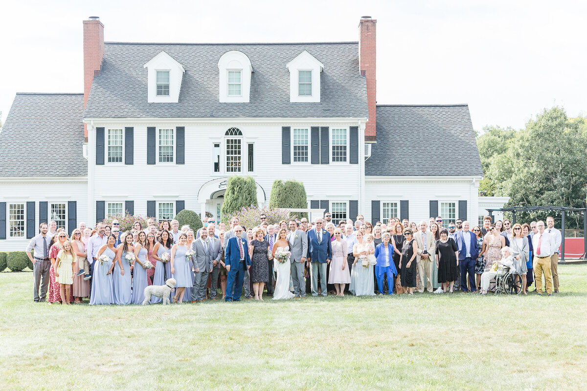 Group Photo of all wedding attendees at a Five Bridge Inn wedding reception. Captured by best Massachusetts wedding photographer Lia Rose Weddings.