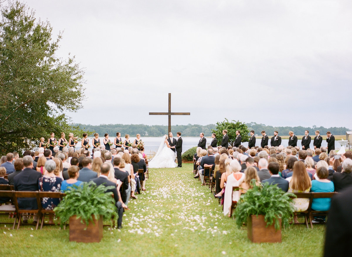 Charleston Wedding Ceremony with Mahogany Cross Waterfront Views Bride and Groom at Altar