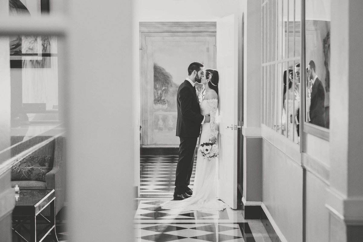Bride and groom leaning on the wall at The Mansion at Oyster Bay