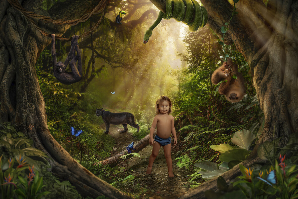 A fantastical image of a young boy in blue shorts standing in the jungle with his animal friends creative by an Asheville Family Photographer